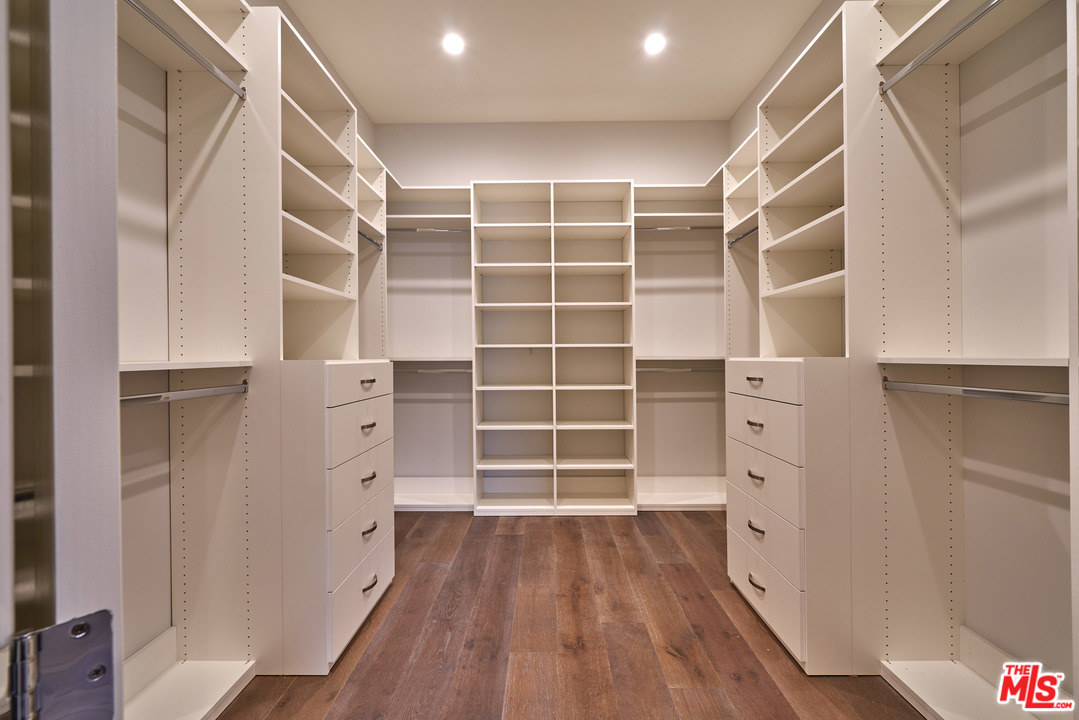 11622 Addison Street Valley Village, CA 91601 - Photo 28 of 39 a view of walk in closet with empty racks
