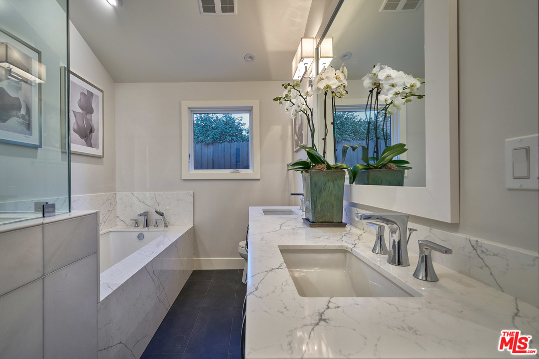 11622 Addison Street Valley Village, CA 91601 - Photo 30 of 39 a bathroom with a tub sink and mirror