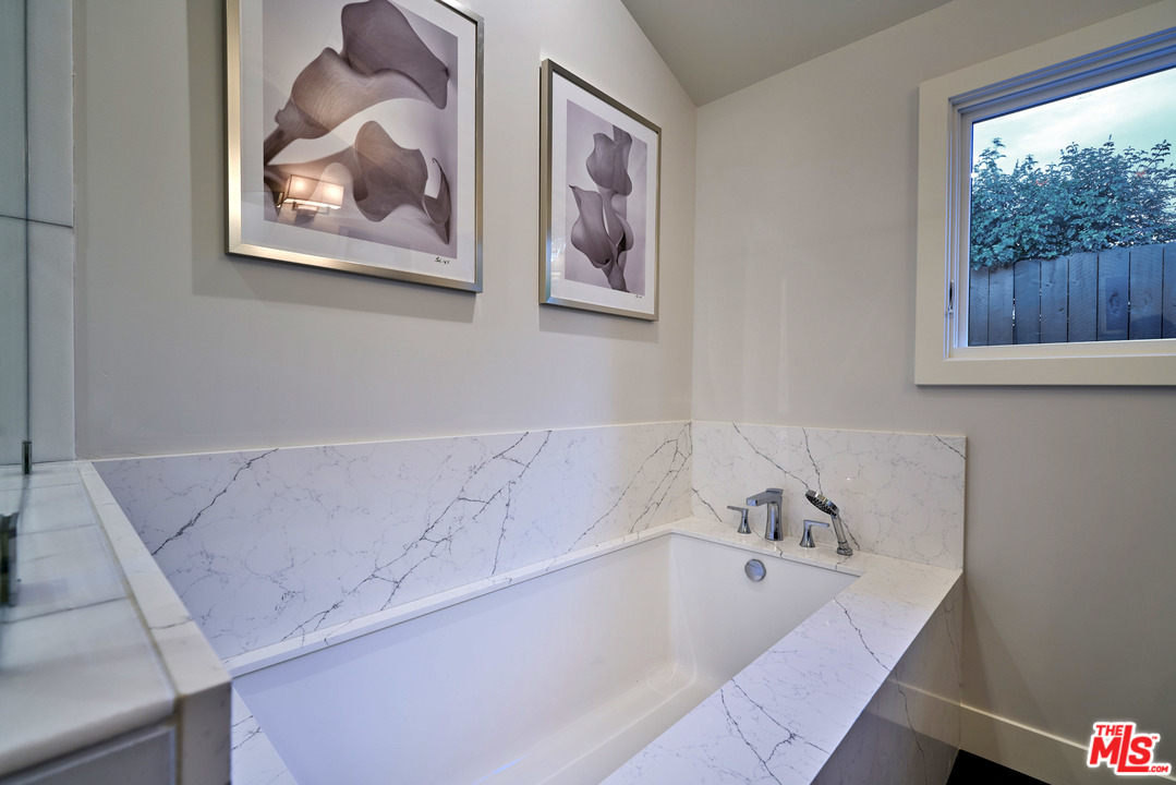 11622 Addison Street Valley Village, CA 91601 - Photo 31 of 39 a bathroom with a bathtub and a window