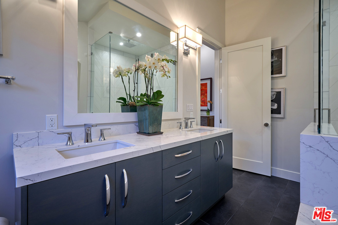 11622 Addison Street Valley Village, CA 91601 - Photo 33 of 39 a bathroom with a double vanity sink and a mirror