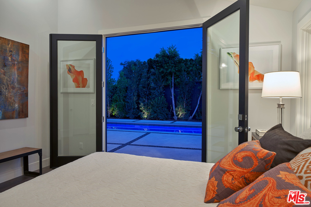 11622 Addison Street Valley Village, CA 91601 - Photo 35 of 39 a bedroom with a bed and a painting on the wall