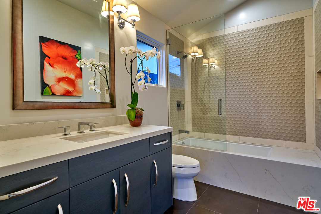 11622 Addison Street Valley Village, CA 91601 - Photo 37 of 39 a bathroom with a sink a toilet and shower