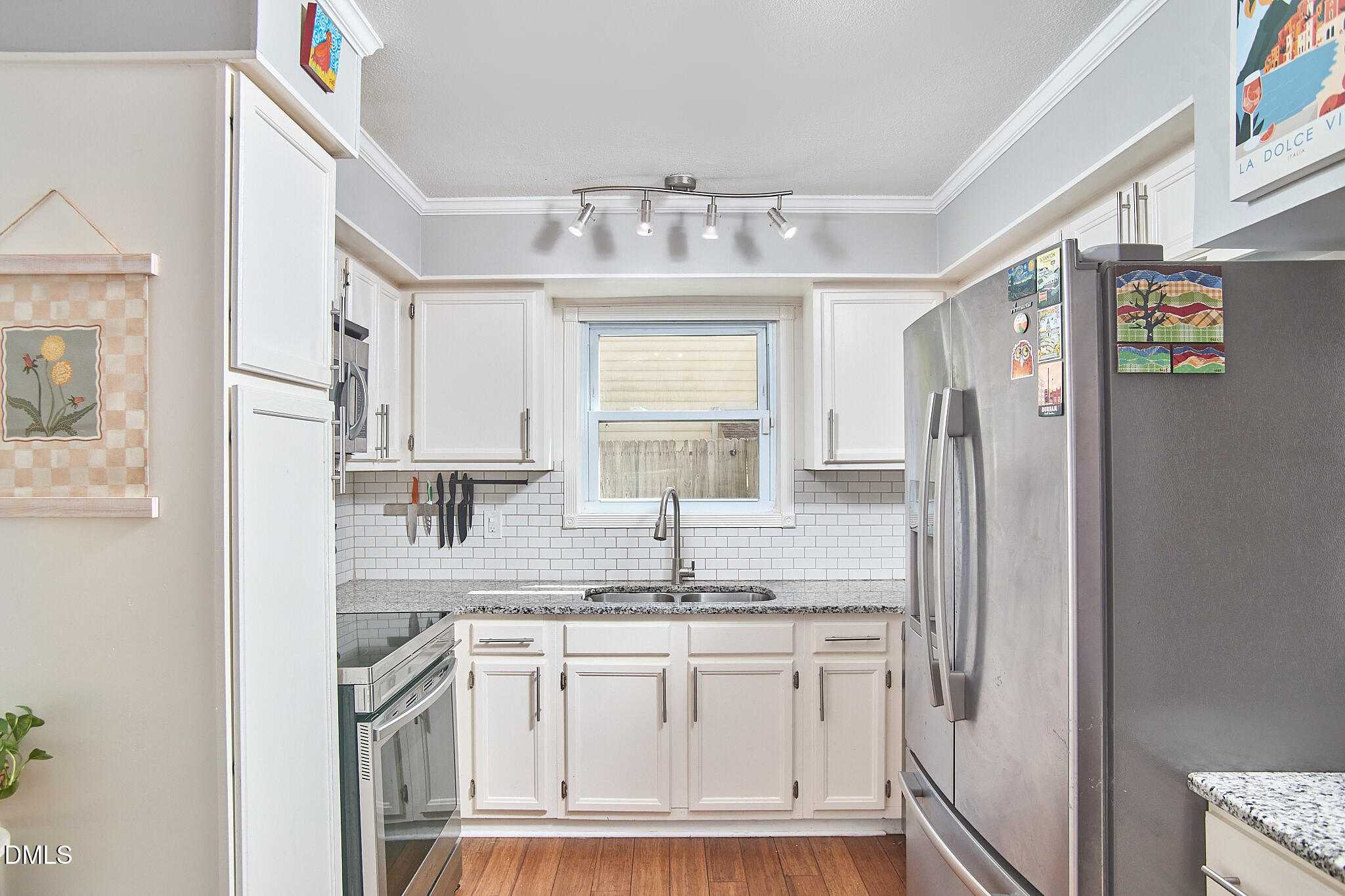 2102 Strebor Street Durham, NC 27705 - Photo 17 of 33 a kitchen with stainless steel appliances granite countertop a sink and refrigerator