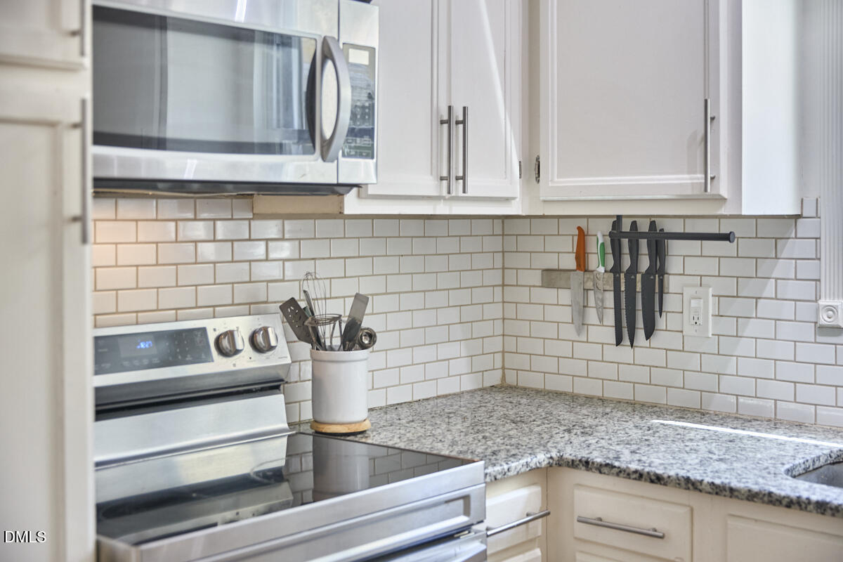 2102 Strebor Street Durham, NC 27705 - Photo 19 of 33 a kitchen with granite countertop white cabinets and appliances