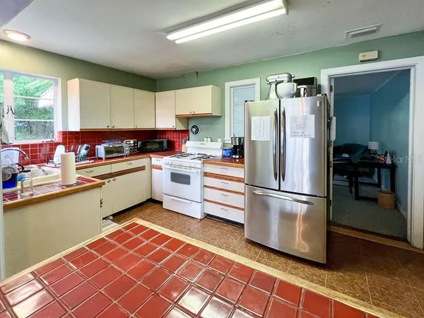 a kitchen with stainless steel appliances granite countertop a refrigerator sink and cabinets