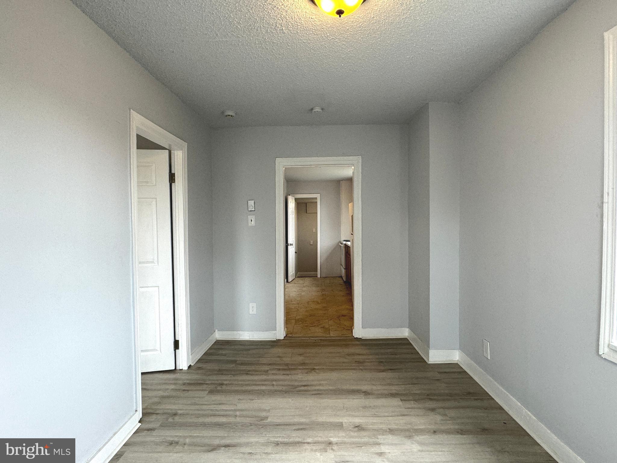 a view of hallway with wooden floor