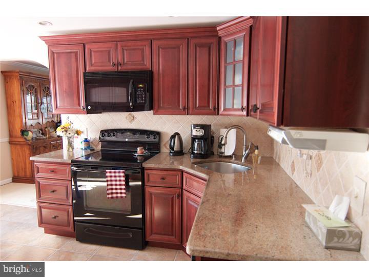 62 Brookline Road Warminster, PA 18974 - Photo 3 of 15 a kitchen with a sink a stove and a microwave