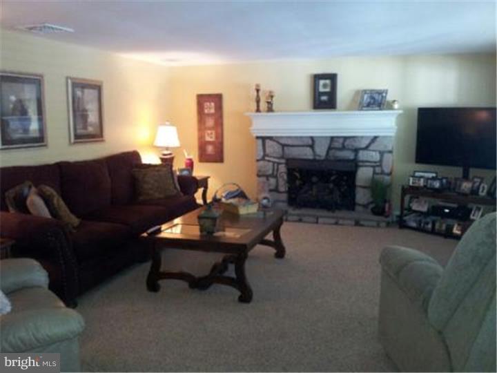 62 Brookline Road Warminster, PA 18974 - Photo 5 of 15 a living room with furniture and a fireplace