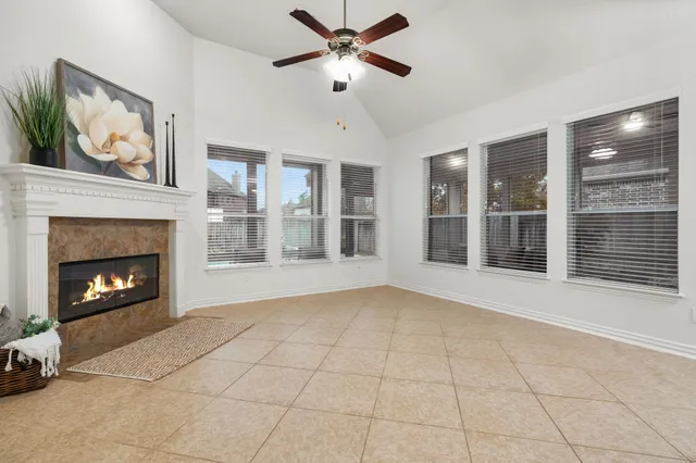 a view of an empty room with window and fire place