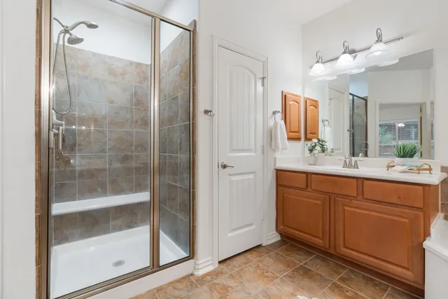 a bathroom with a shower sink and mirror
