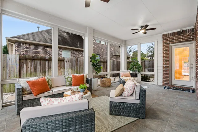a bedroom with furniture and large windows