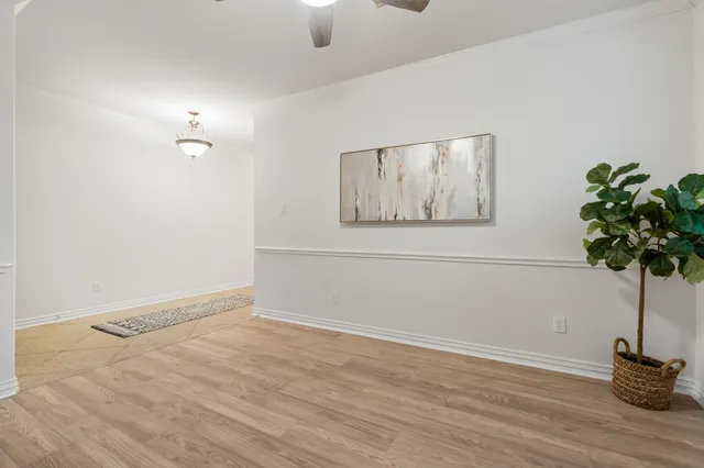 a view of a room with wooden floor and a potted plant