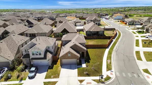 an aerial view of residential houses with outdoor space