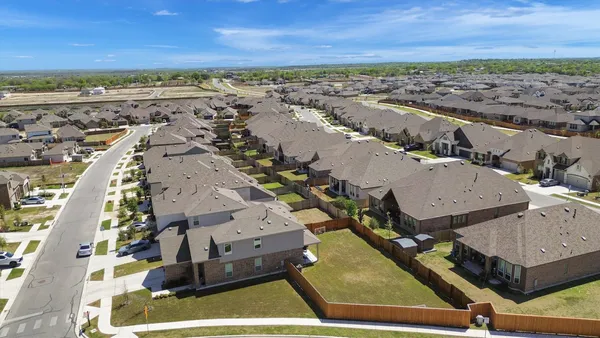 an aerial view of a swimming pool patio and mountain view in back