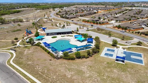 an aerial view of a residential houses with city view
