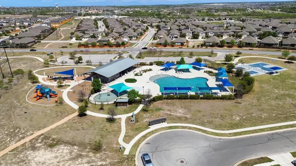 an aerial view of a house with swimming pool outdoor seating