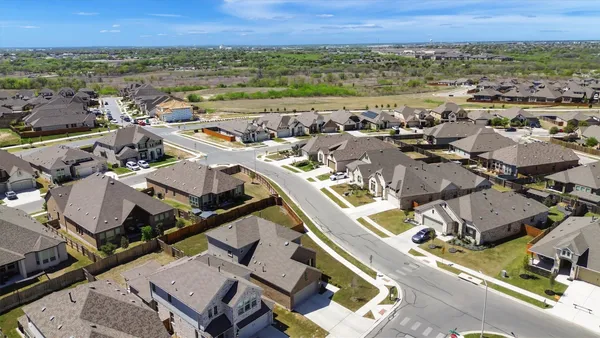 an aerial view of a house with swimming pool and ocean view