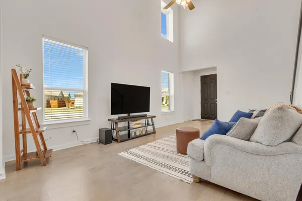 a kitchen with stainless steel appliances a dining table chairs and refrigerator