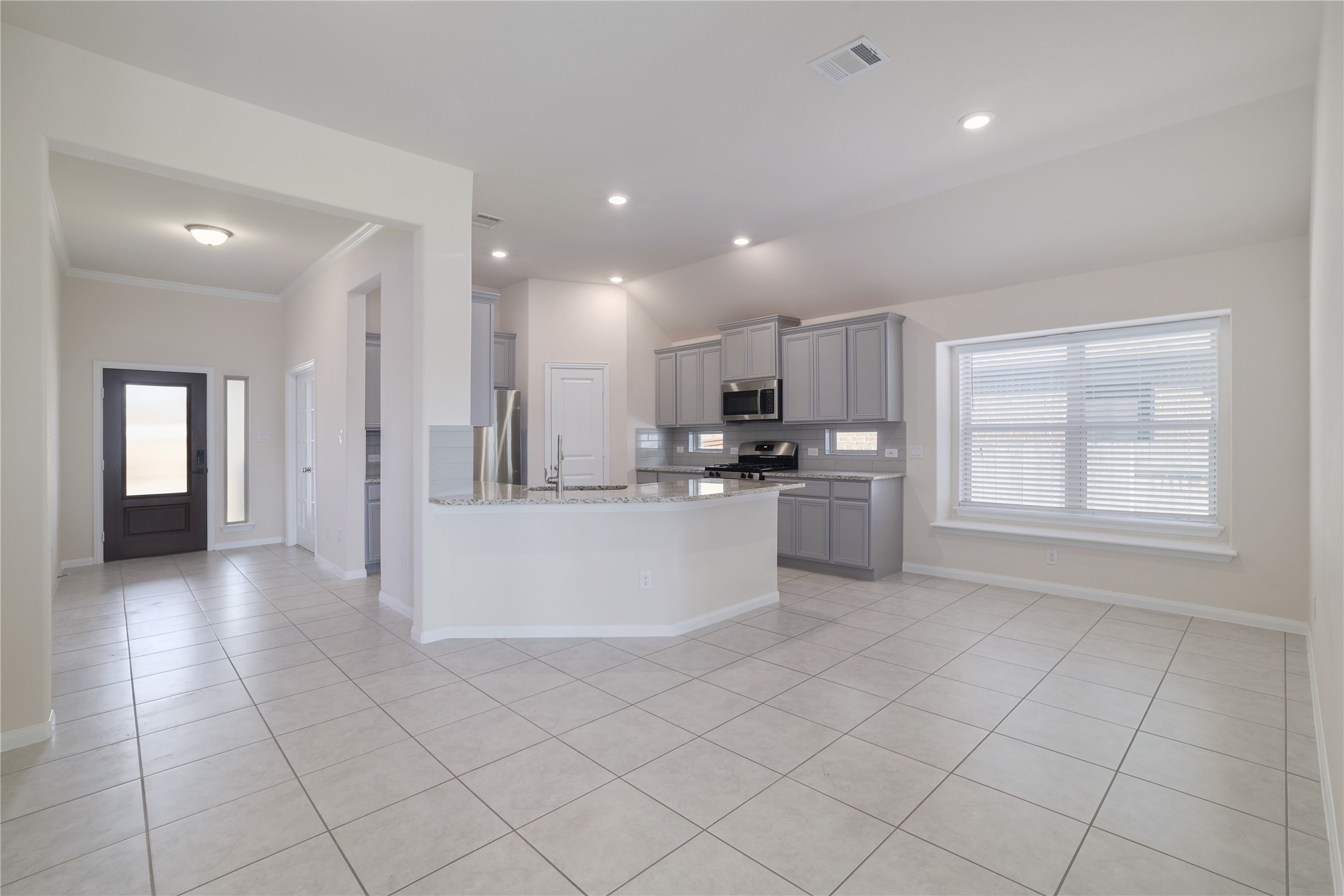 3341 Pauling Loop Round Rock, TX 78665 - Photo 13 of 40 Kitchen featuring gray cabinetry, granite countertops, stainless steel appliances, light tile patterned flooring, and recessed lighting