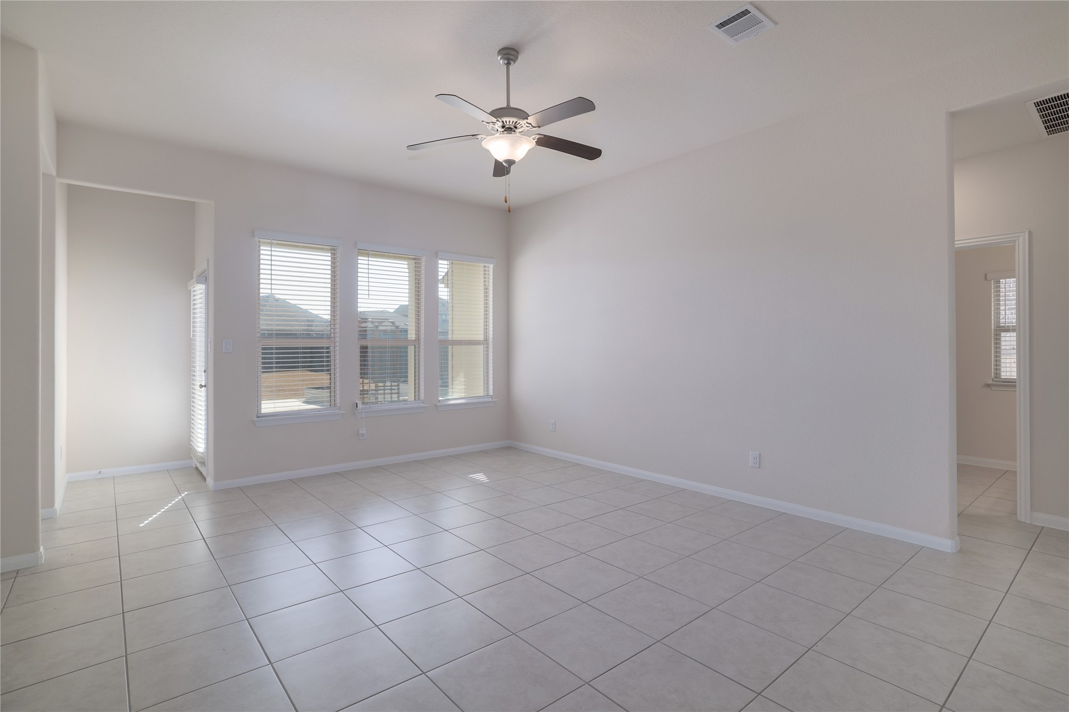 3341 Pauling Loop Round Rock, TX 78665 - Photo 14 of 40 Living room with ceiling fan and light tile patterned floors