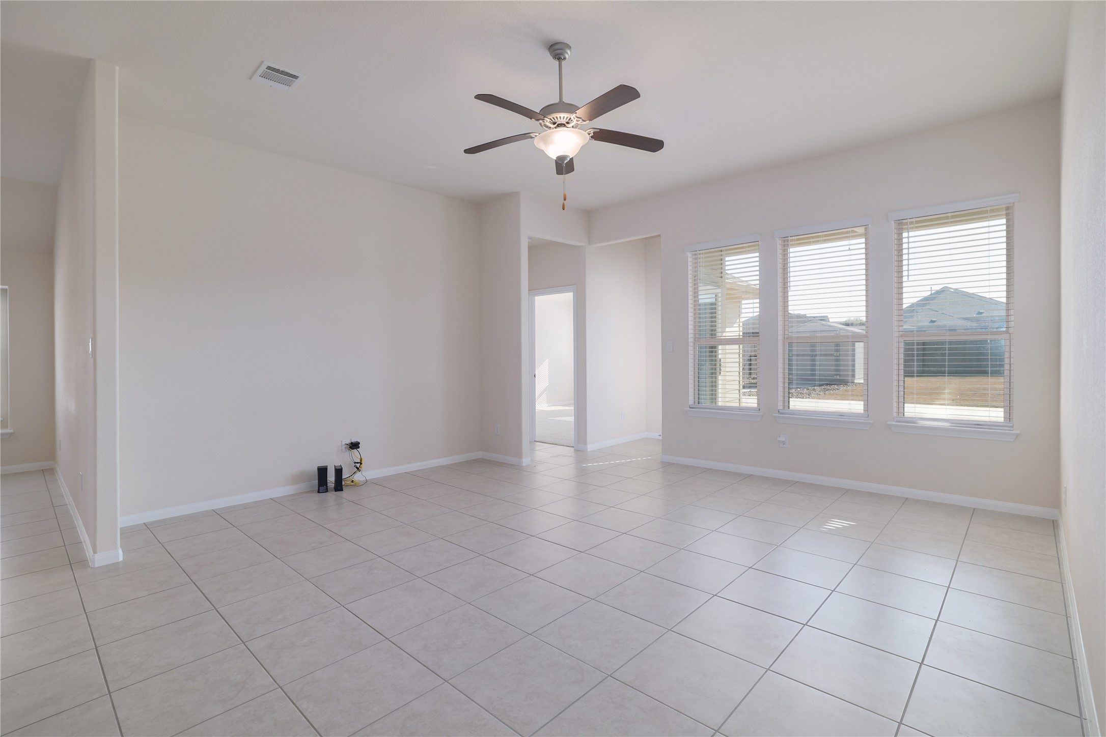 3341 Pauling Loop Round Rock, TX 78665 - Photo 15 of 40 Living room with ceiling fan and light tile patterned floors