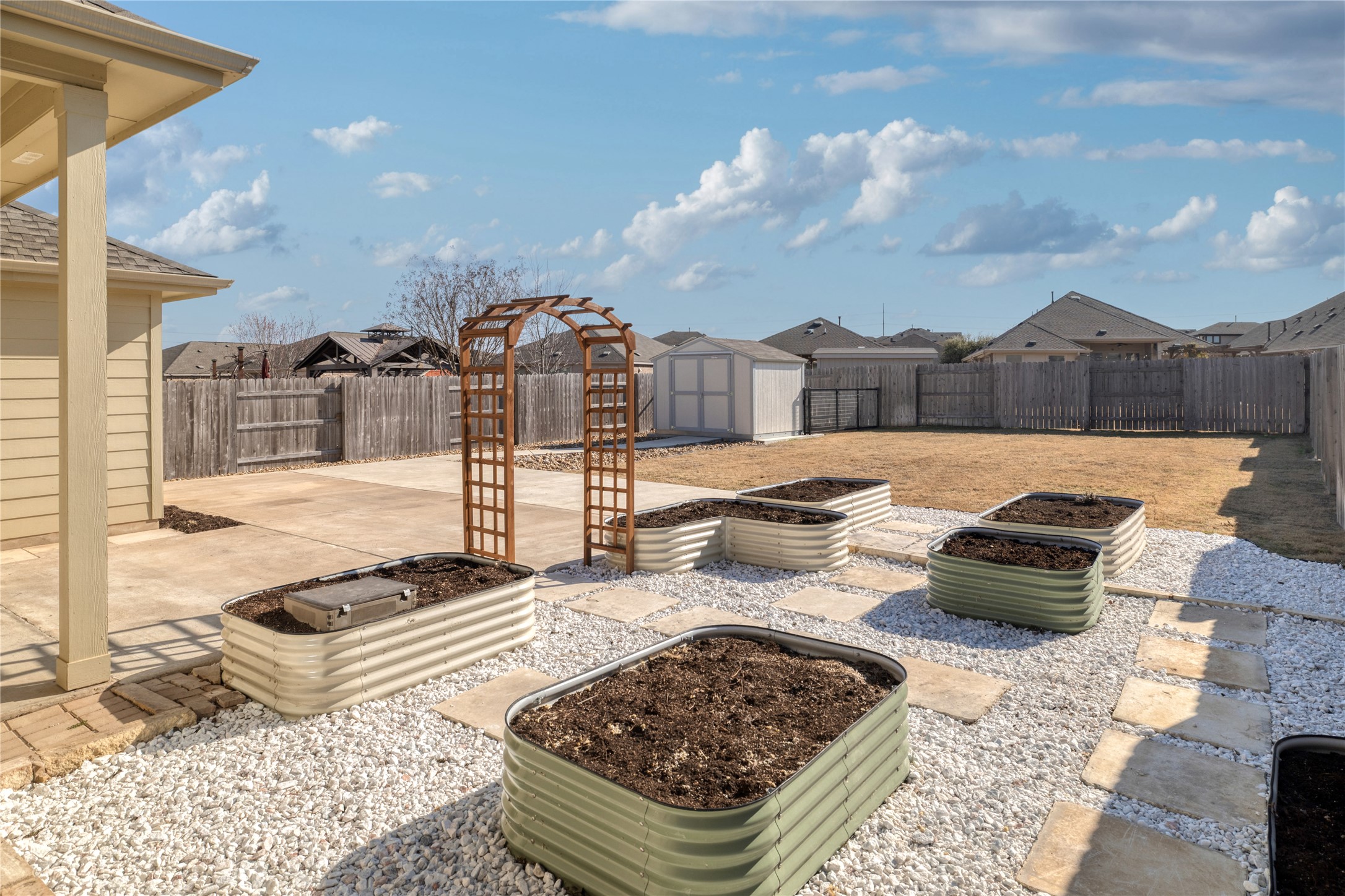 3341 Pauling Loop Round Rock, TX 78665 - Photo 27 of 40 Fenced backyard with a patio, a storage shed, and raised garden planters