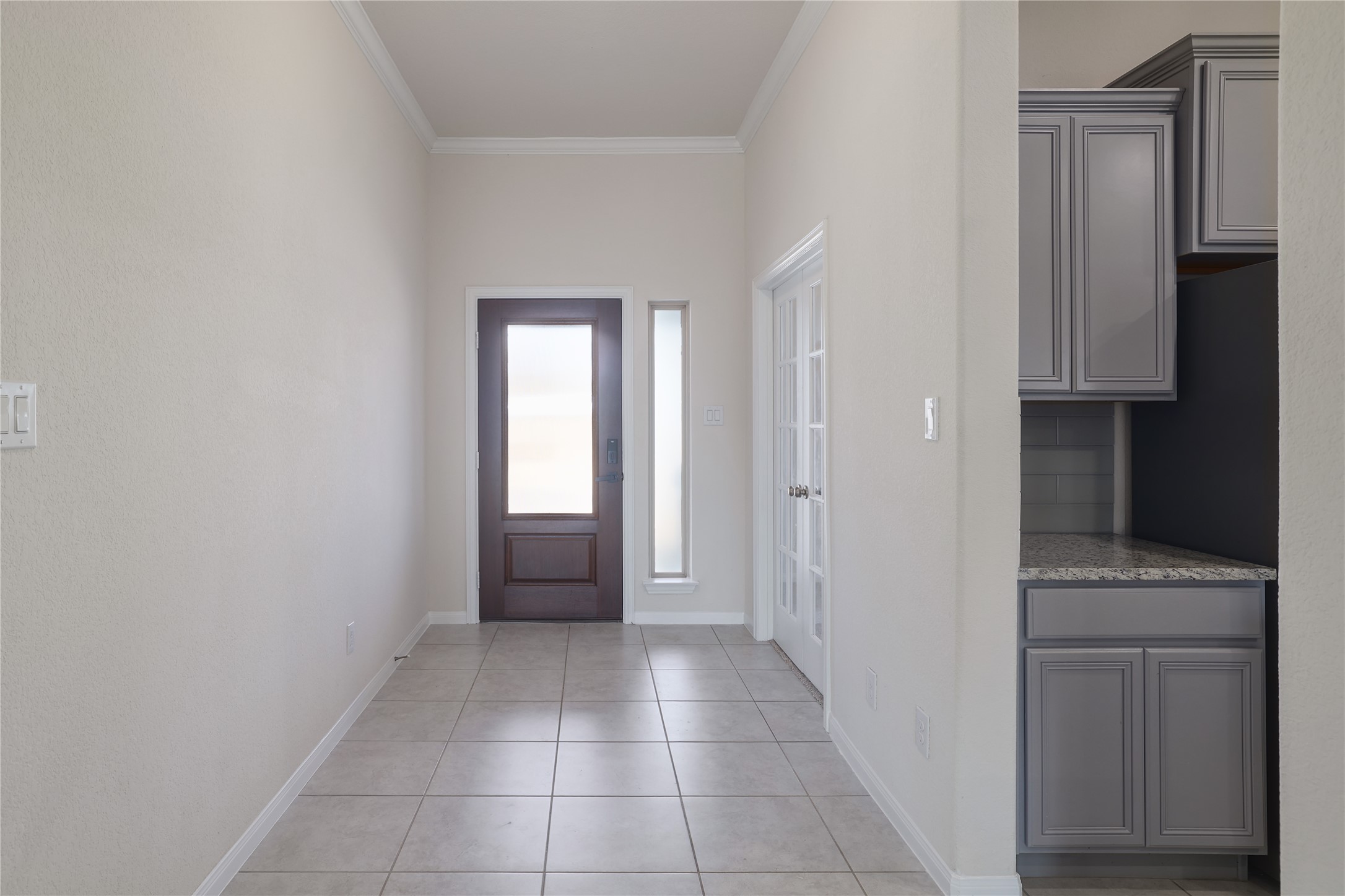 3341 Pauling Loop Round Rock, TX 78665 - Photo 3 of 40 Foyer entrance with crown molding and light tile patterned floors