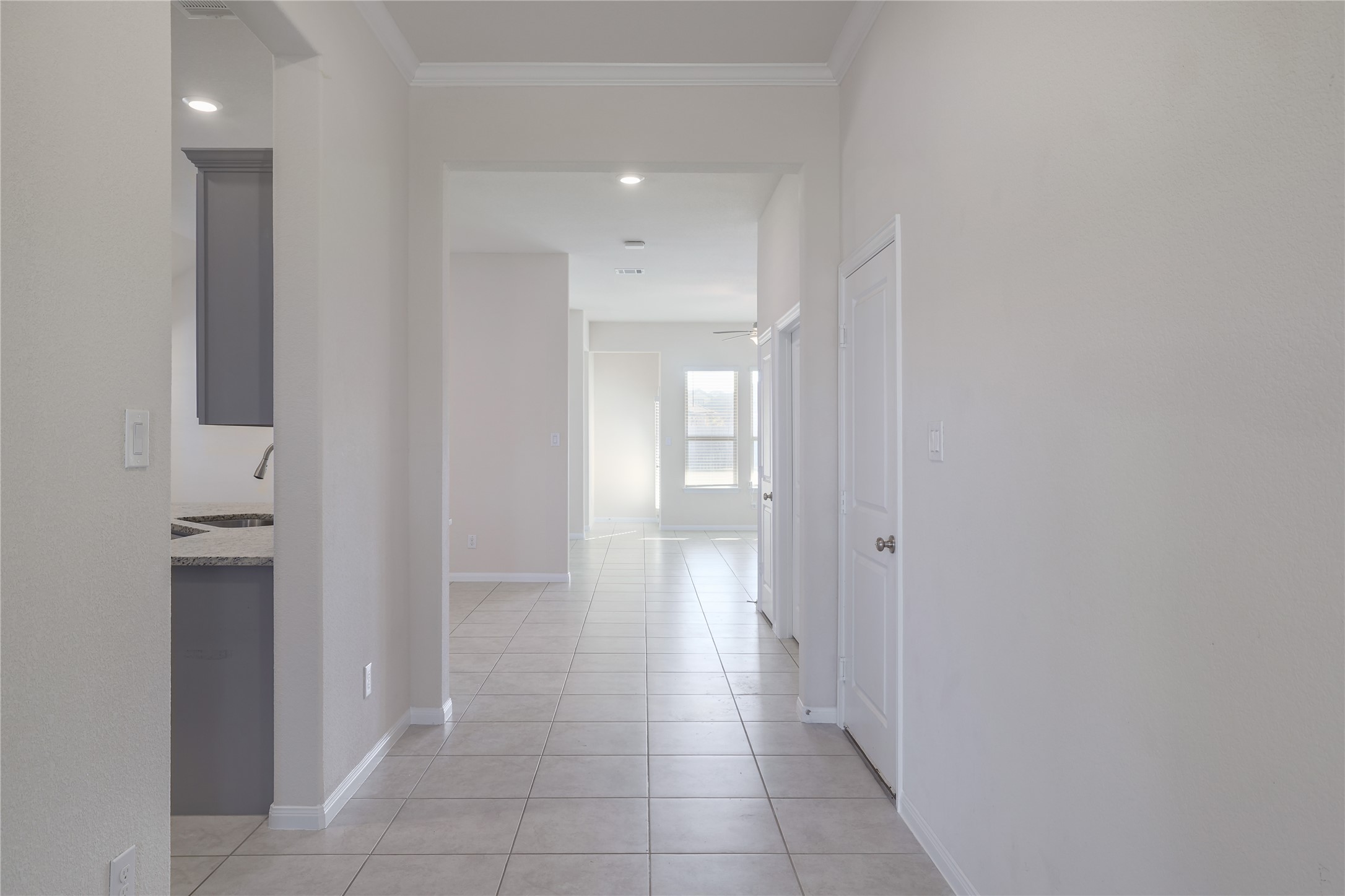 3341 Pauling Loop Round Rock, TX 78665 - Photo 5 of 40 Hallway with light tile patterned flooring, crown molding, and recessed lighting