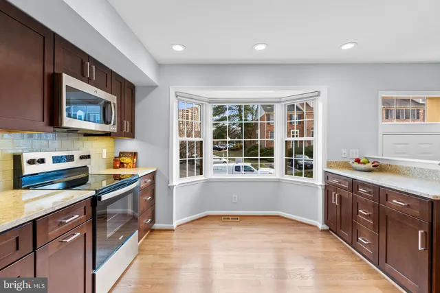 a kitchen with stainless steel appliances granite countertop a stove and a sink