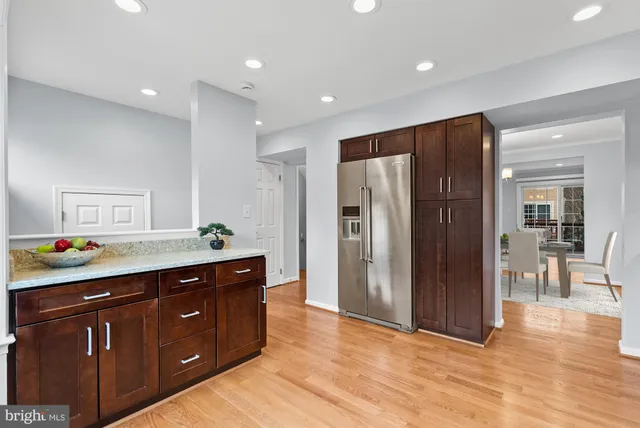 a view of kitchen with stainless steel appliances granite countertop a refrigerator and a sink