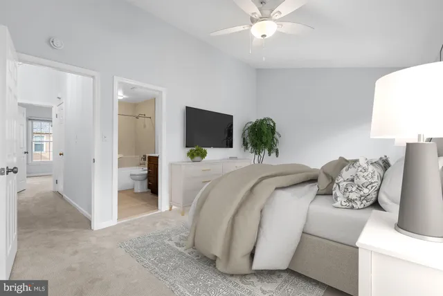 a spacious bedroom with a bed and a chandelier