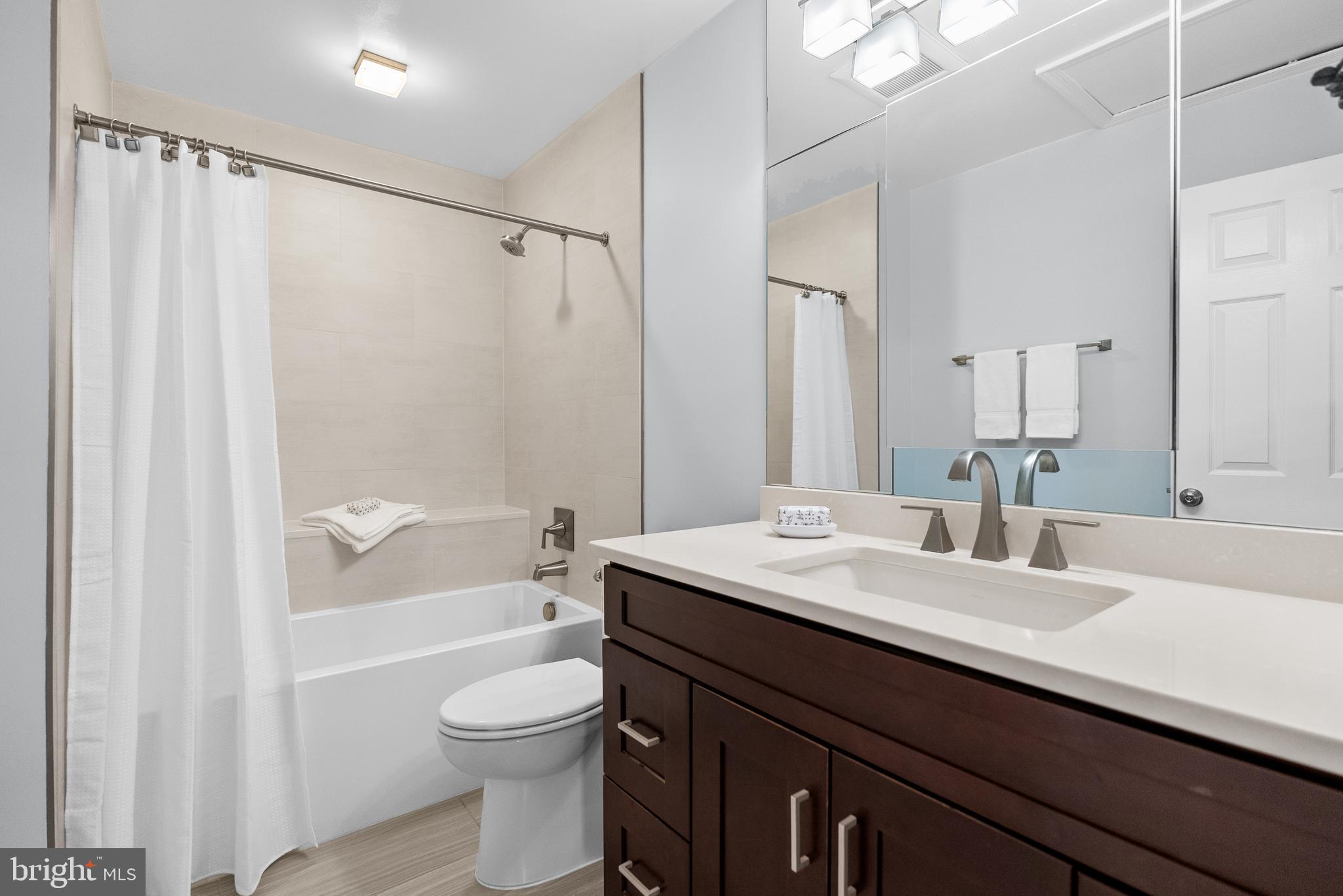 5465 Grove Ridge Way, Unit 123 Rockville, MD 20852 - Photo 20 of 39 a bathroom with a sink a toilet and shower