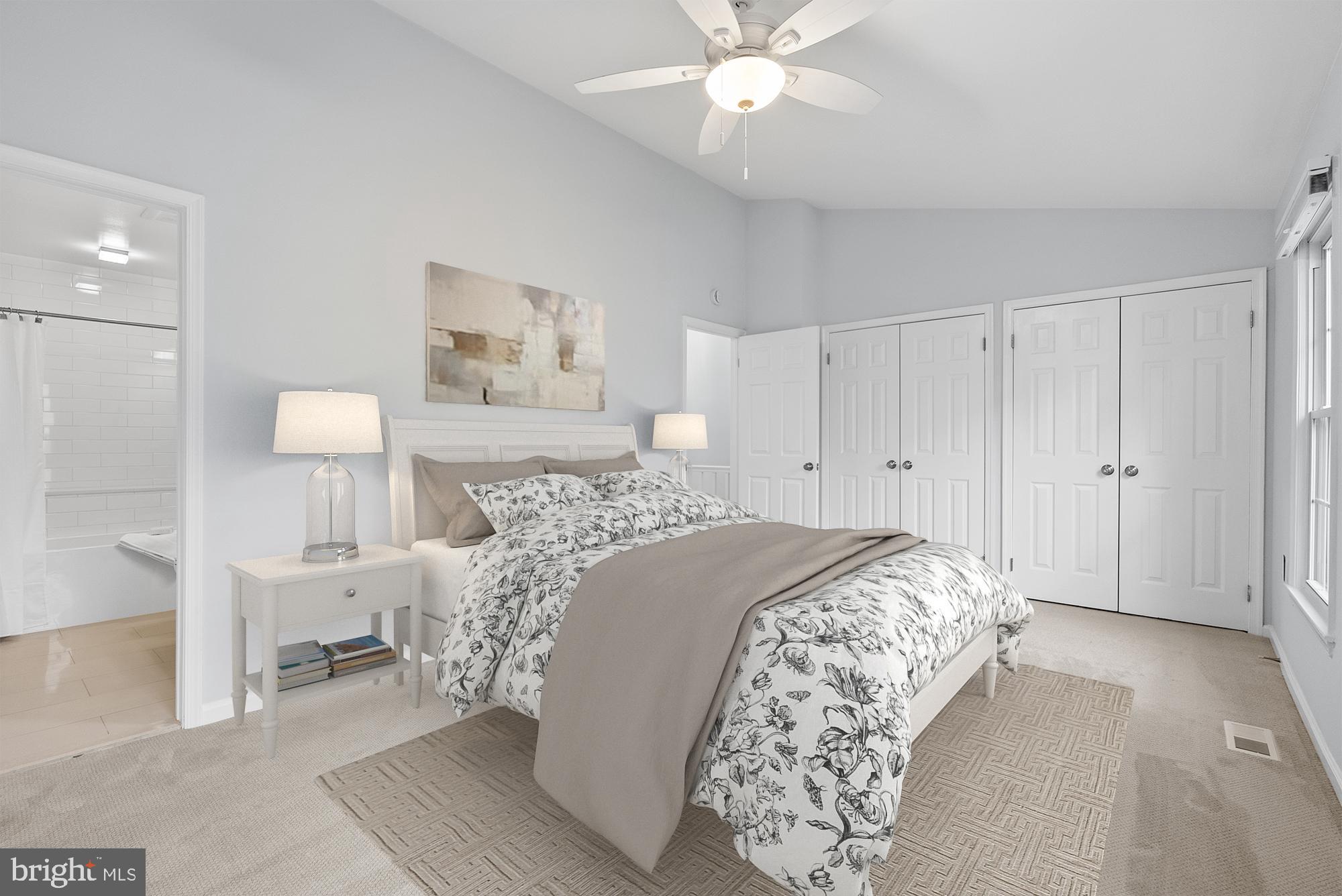 5465 Grove Ridge Way, Unit 123 Rockville, MD 20852 - Photo 22 of 39 a bedroom with a large bed and a chandelier
