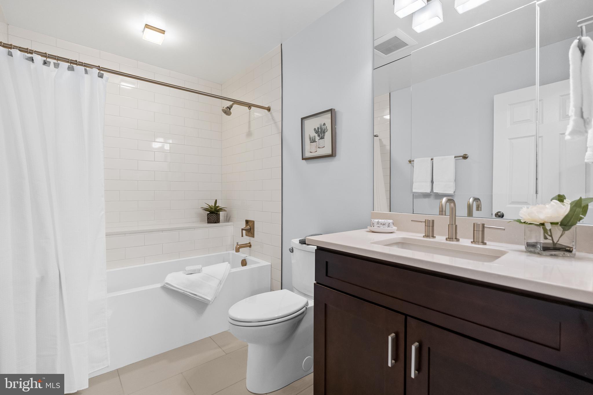 5465 Grove Ridge Way, Unit 123 Rockville, MD 20852 - Photo 23 of 39 a bathroom with a sink a toilet and shower