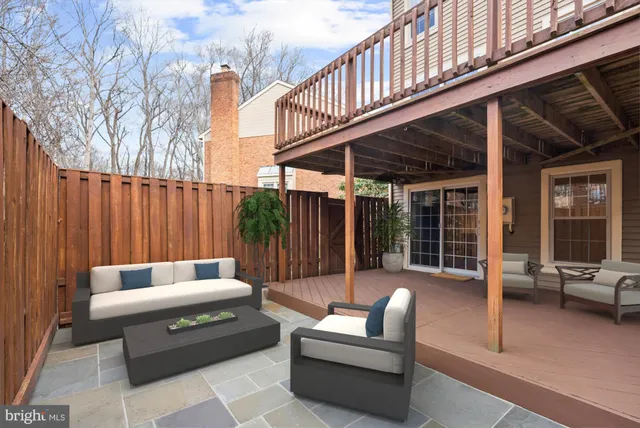 a roof deck with couches and a barbeque