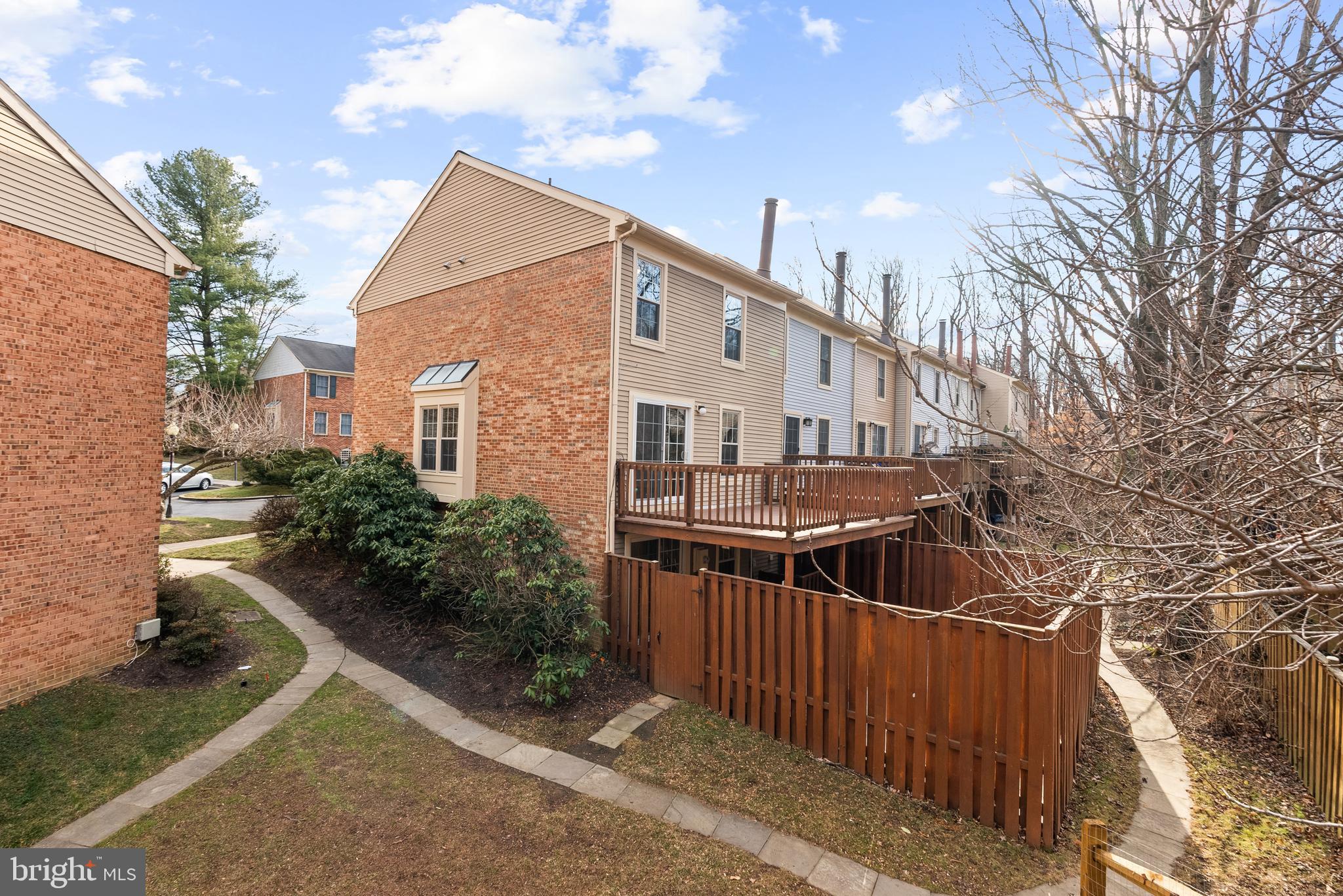 5465 Grove Ridge Way, Unit 123 Rockville, MD 20852 - Photo 30 of 39 a view of a street with brick house and large trees