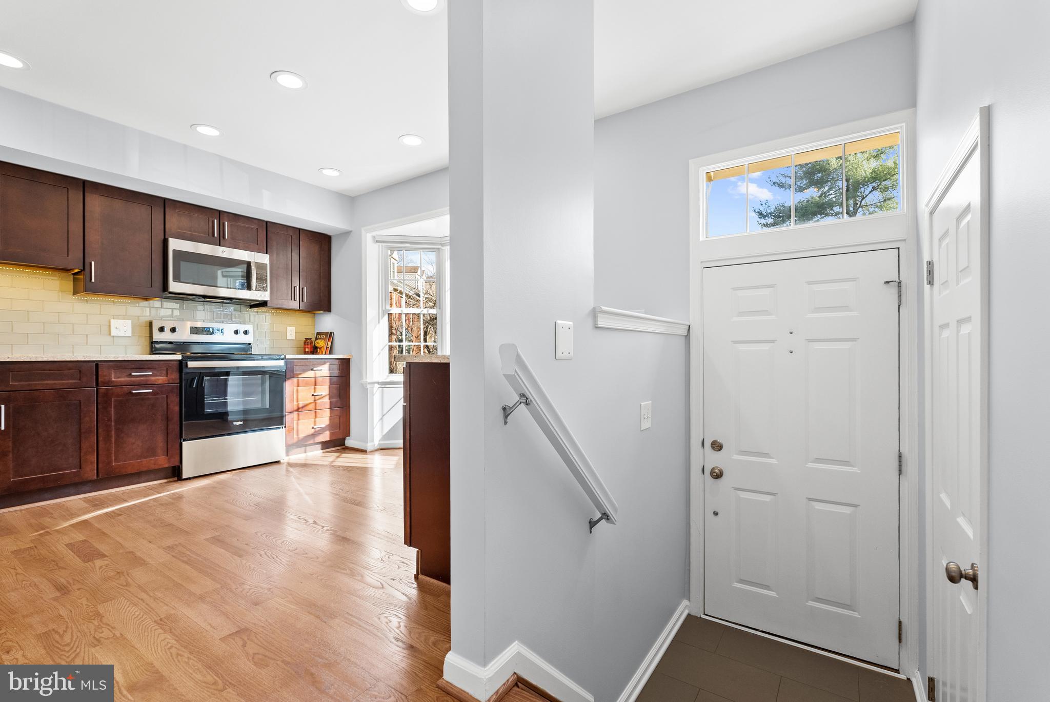 5465 Grove Ridge Way, Unit 123 Rockville, MD 20852 - Photo 7 of 39 a kitchen with stainless steel appliances granite countertop a refrigerator and a stove top oven