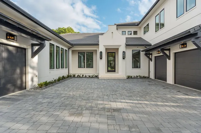 a bathroom with a double vanity sink a mirror and a bathtub