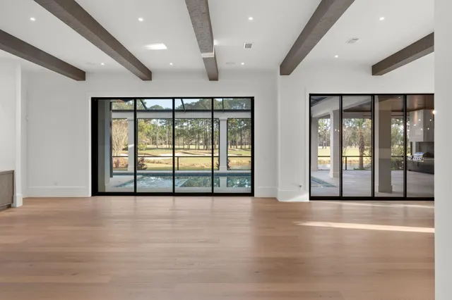 a kitchen that has a sink a stove and a wooden floor