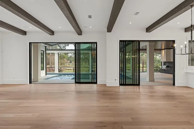 a large white kitchen with granite countertop a stove and a sink