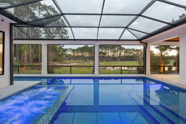 an aerial view of residential houses with outdoor space and city view