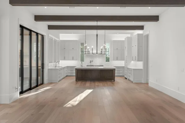 a view of a small space with wooden floor and a window