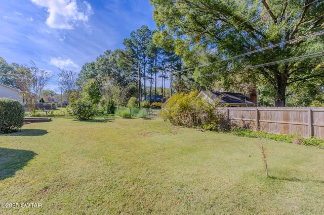 a backyard of a house with lots of green space