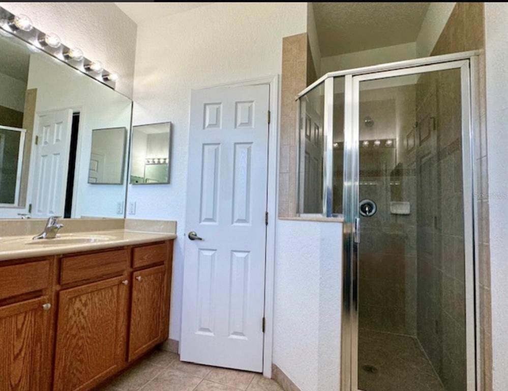 3489 Allegra Circle St. Cloud, FL 34772 - Photo 12 of 29 a bathroom with a double vanity sink and mirror