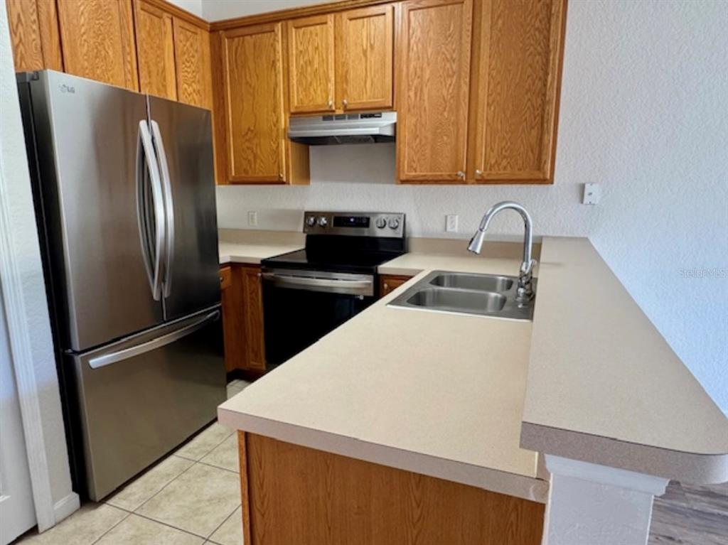 3489 Allegra Circle St. Cloud, FL 34772 - Photo 2 of 29 a kitchen with a refrigerator sink and stove