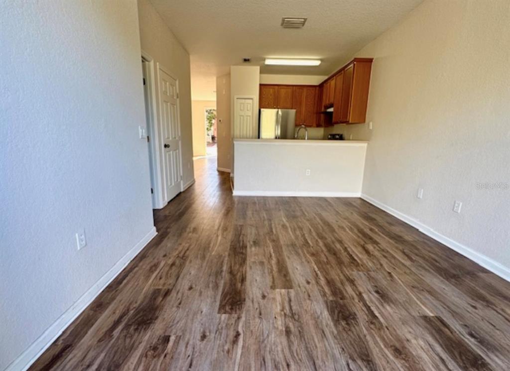 3489 Allegra Circle St. Cloud, FL 34772 - Photo 5 of 29 a view of a kitchen with wooden floor and a sink