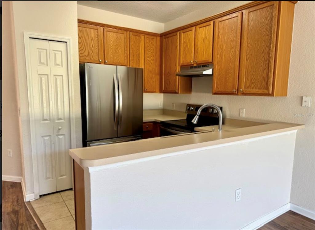 3489 Allegra Circle St. Cloud, FL 34772 - Photo 6 of 29 a kitchen with stainless steel appliances a refrigerator and a sink