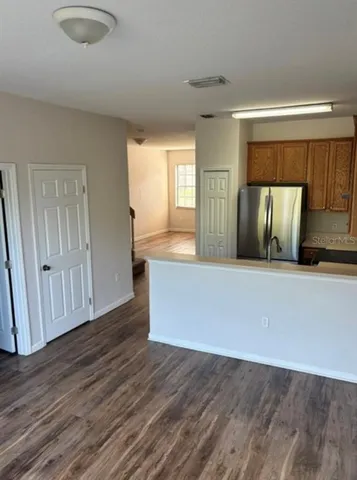 a view of kitchen with wooden floor and staircase