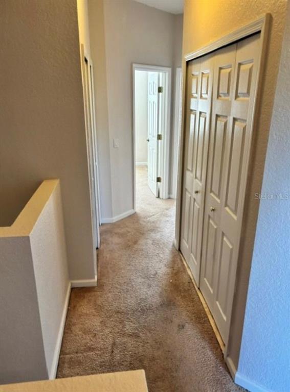 3489 Allegra Circle St. Cloud, FL 34772 - Photo 9 of 29 a view of a hallway with wooden floor and staircase