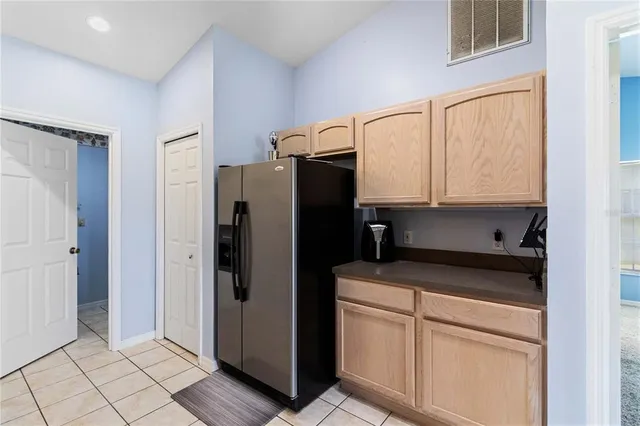 a kitchen with stainless steel appliances a refrigerator sink and cabinets